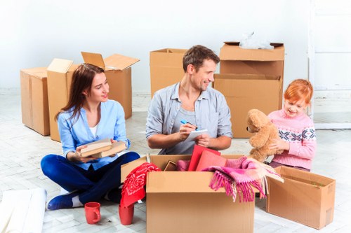 Professional movers handling office furniture and equipment for a Hammersmith business
