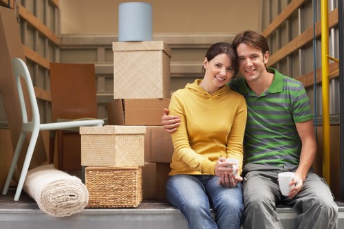 Packed moving boxes arranged in a Hammersmith flat with narrow access