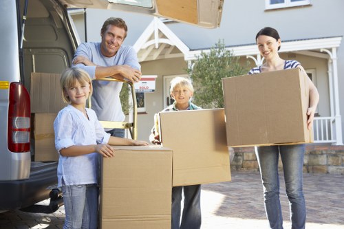Careful loading of sofas, tables, and desks during Hammersmith pick-up
