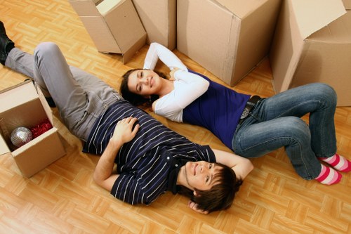 Local removal team handling furniture in a Hammersmith flat move